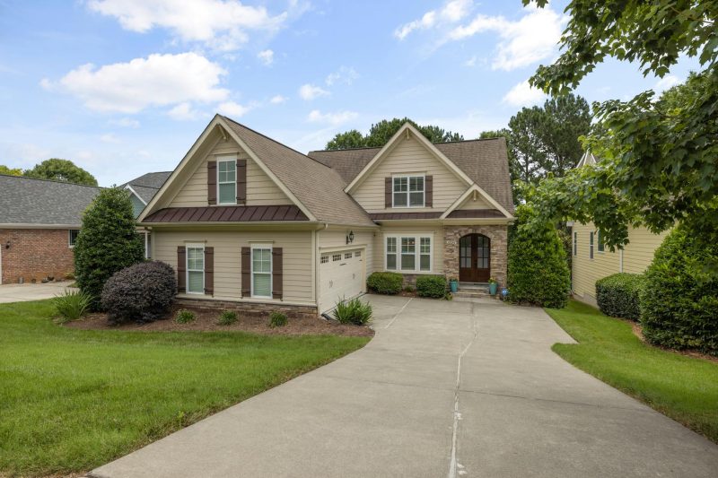 Suburban family home with a well-maintained lawn and driveway.