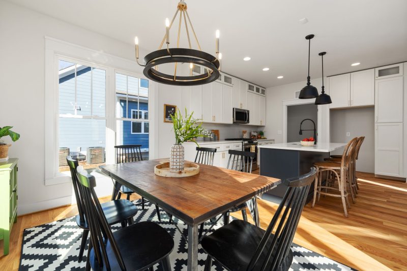 Bright, modern kitchen and dining area featuring stylish furniture and abundant natural light.